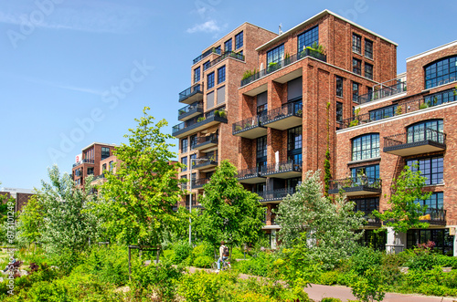 Rotterdam, The Netherlands, June 6, 2024: new Little C residential neighbourhood with equally new Tuschinski Park in the foreground photo