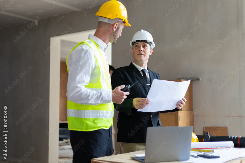 Businessman, contractors and engineers working at construction sites are construction inspector and supervise the work according to plans. Coworker cooperation and teamwork to ensure workplace safety. Businessman, contractors and engineers working at construction sites are construction inspector and supervise the work according to plans. Coworker cooperation and teamwork to ensure workplace safety.