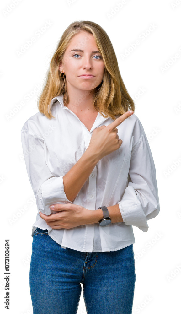 Beautiful young business woman over isolated background Pointing with hand finger to the side showing advertisement, serious and calm face Beautiful young business woman over isolated background Pointing with hand finger to the side showing advertisement, serious and calm face