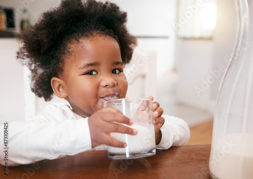 Принти на полотні Black girl, kid and drinking milk in home portrait, vitamin d and beverage for growth development