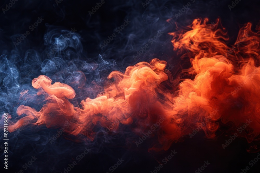 Fototapeta premium Swirling orange and blue smoke against a dark background