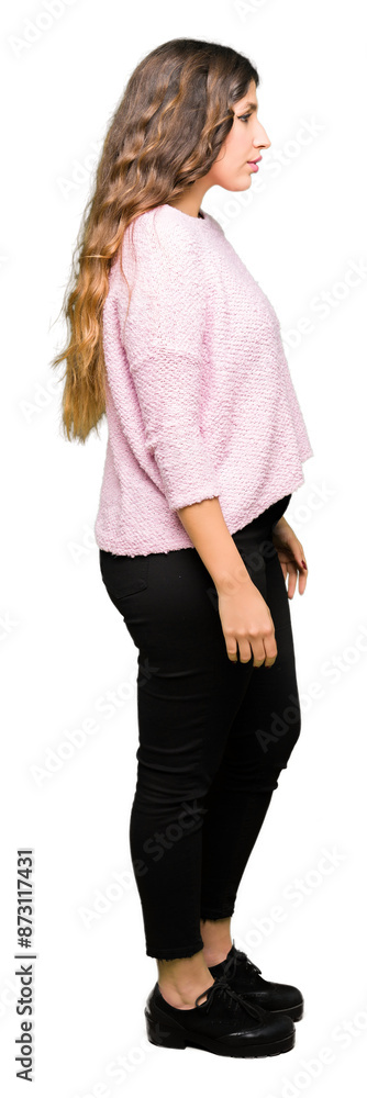 Young beautiful woman wearing pink sweater looking to side, relax profile pose with natural face with confident smile. Young beautiful woman wearing pink sweater looking to side, relax profile pose with natural face with confident smile.