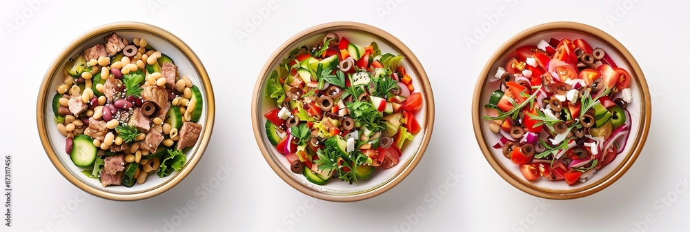 Three bowls of salad with the ingredients arranged in layers, each bowl containing different types of leaves and vegetables Three bowls of salad with the ingredients arranged in layers, each bowl containing different types of leaves and vegetables