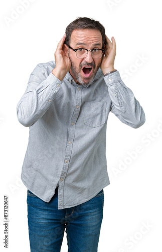 Handsome middle age elegant senior man wearing glasses over isolated background Trying to hear both hands on ear gesture, curious for gossip. Hearing problem, deaf