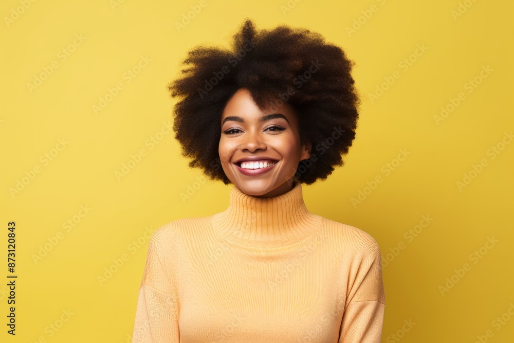 Portrait of a happy afro-american woman in her 20s wearing a classic turtleneck sweater isolated on pastel yellow background Portrait of a happy afro-american woman in her 20s wearing a classic turtleneck sweater isolated on pastel yellow background