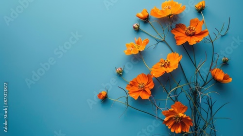 Seasonal concept Vintage orange flowers on blue background with space for text photo