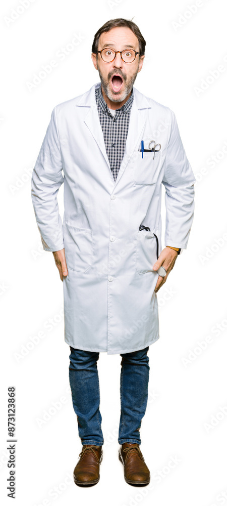 Middle age doctor men wearing medical coat afraid and shocked with surprise expression, fear and excited face. Middle age doctor men wearing medical coat afraid and shocked with surprise expression, fear and excited face.