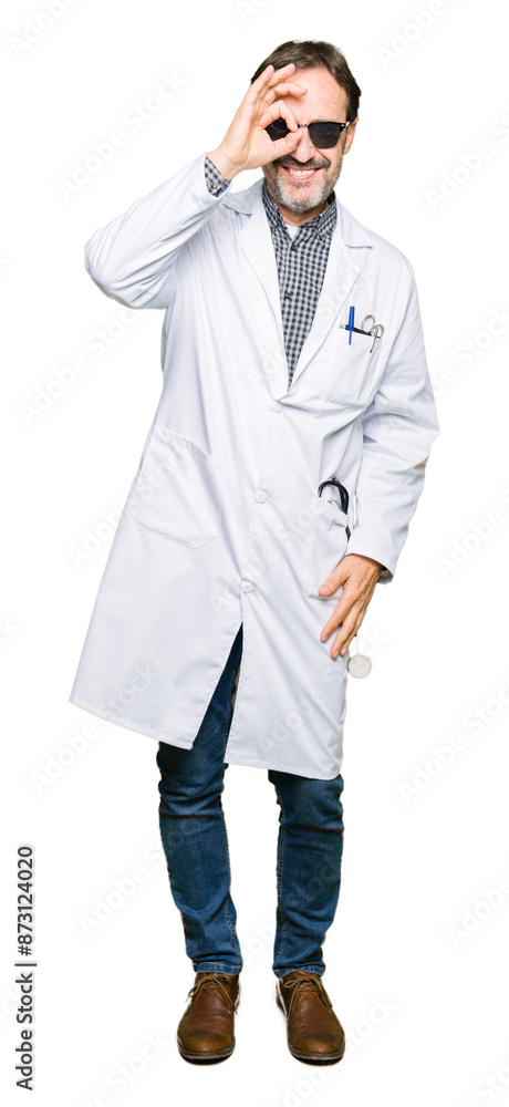Handsome middle age doctor man wearing sunglasses doing ok gesture with hand smiling, eye looking through fingers with happy face. Handsome middle age doctor man wearing sunglasses doing ok gesture with hand smiling, eye looking through fingers with happy face.