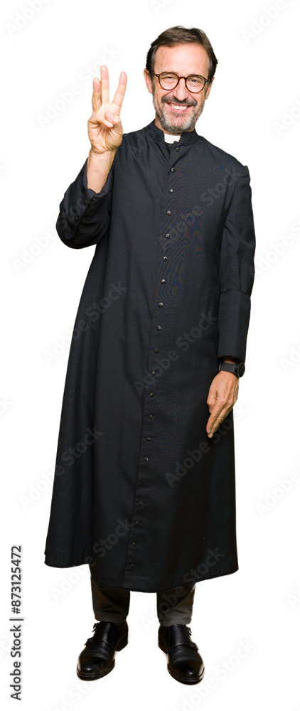Middle age priest man wearing catholic robe showing and pointing up with fingers number three while smiling confident and happy. Middle age priest man wearing catholic robe showing and pointing up with fingers number three while smiling confident and happy.