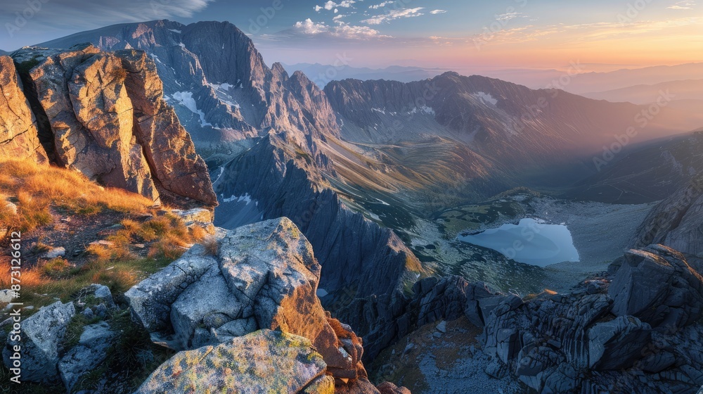 Obraz premium A breathtaking view of a mountain range with rugged cliffs and pristine alpine lakes, at sunrise.