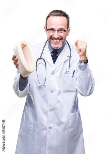 Middle age senior hoary doctor man holding neck collar over isolated background screaming proud and celebrating victory and success very excited, cheering emotion