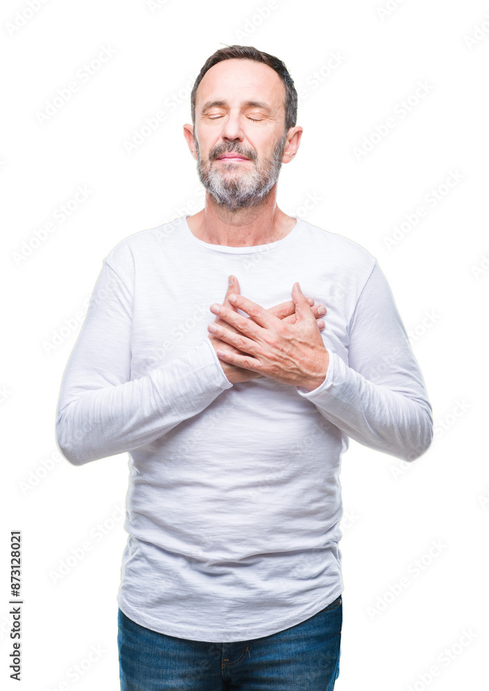 Middle age hoary senior man wearing white t-shirt over isolated background smiling with hands on chest with closed eyes and grateful gesture on face. Health concept. Middle age hoary senior man wearing white t-shirt over isolated background smiling with hands on chest with closed eyes and grateful gesture on face. Health concept.