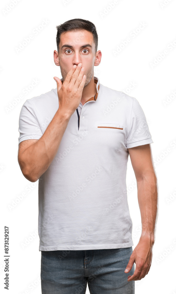 Handsome young casual man wearing white t-shirt cover mouth with hand shocked with shame for mistake, expression of fear, scared in silence, secret concept Handsome young casual man wearing white t-shirt cover mouth with hand shocked with shame for mistake, expression of fear, scared in silence, secret concept