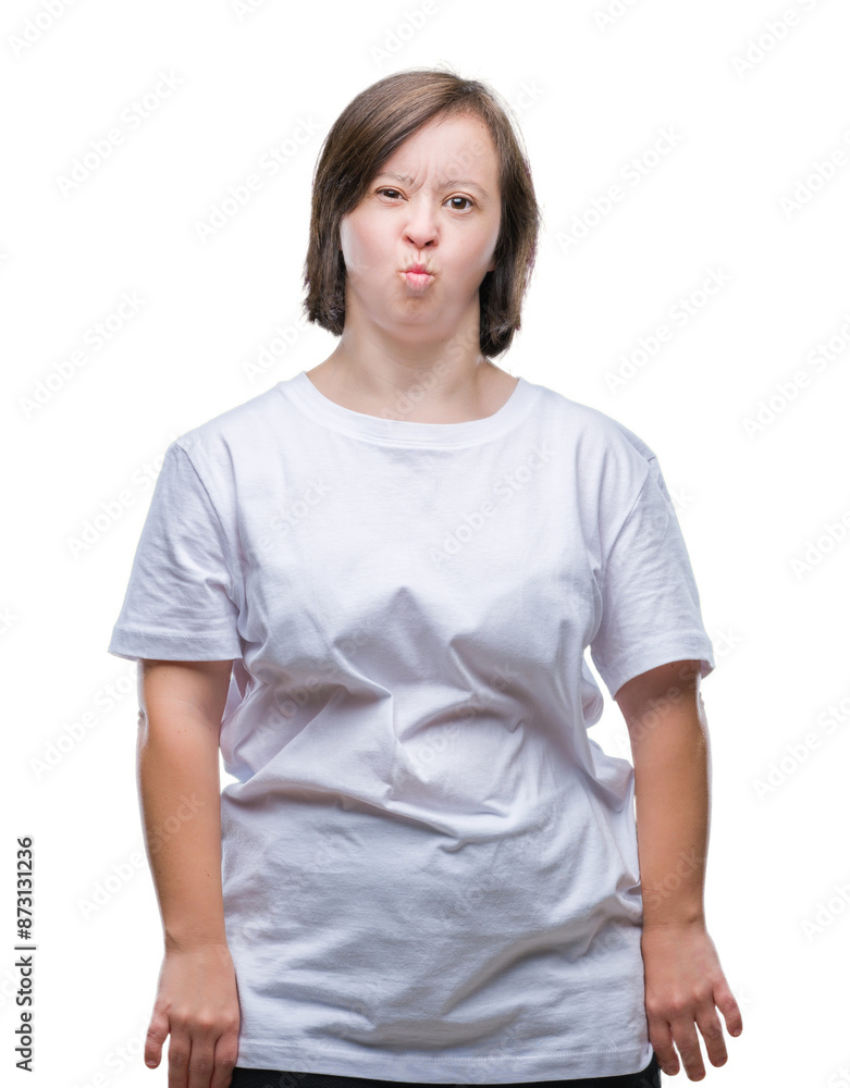 Young adult woman with down syndrome over isolated background puffing cheeks with funny face. Mouth inflated with air, crazy expression. Young adult woman with down syndrome over isolated background puffing cheeks with funny face. Mouth inflated with air, crazy expression.