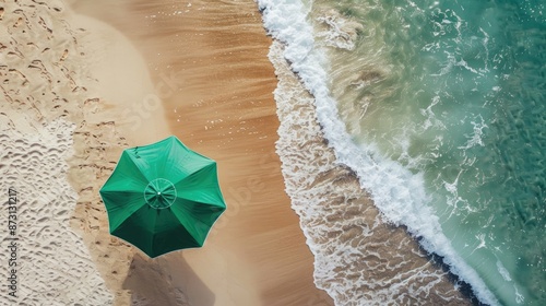 Fototapeta Naklejka Na Ścianę i Meble -  Aerial view of sandy coast with green beach umbrella