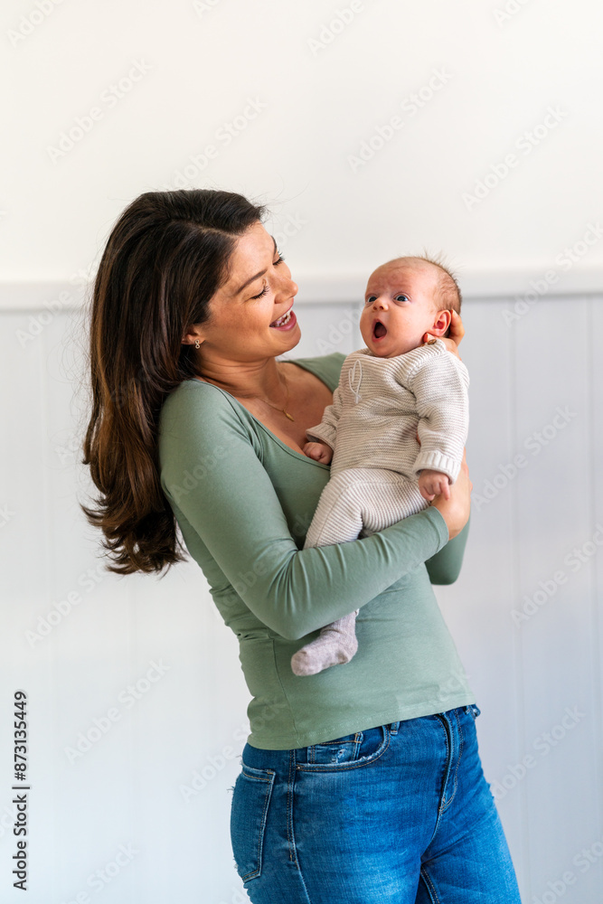 Family love child and parenthood concept. Happy smiling young mother with little baby at home
