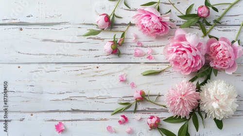 Fototapeta Naklejka Na Ścianę i Meble -  Faux peonies blossoming on a white wooden backdrop with room for text