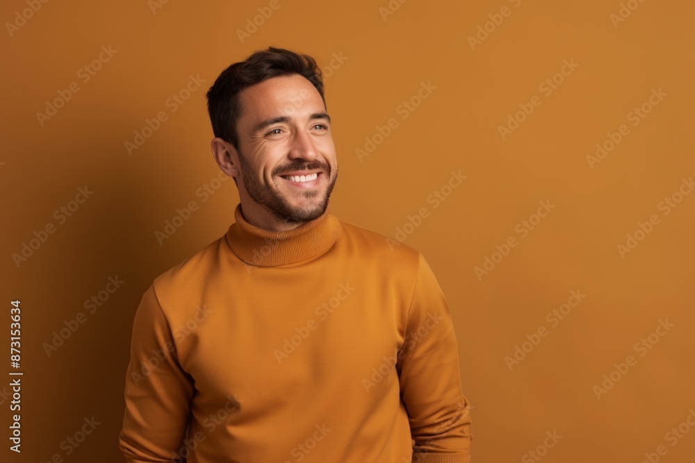 Portrait of a joyful man in his 30s wearing a thermal fleece pullover on soft brown background Portrait of a joyful man in his 30s wearing a thermal fleece pullover on soft brown background