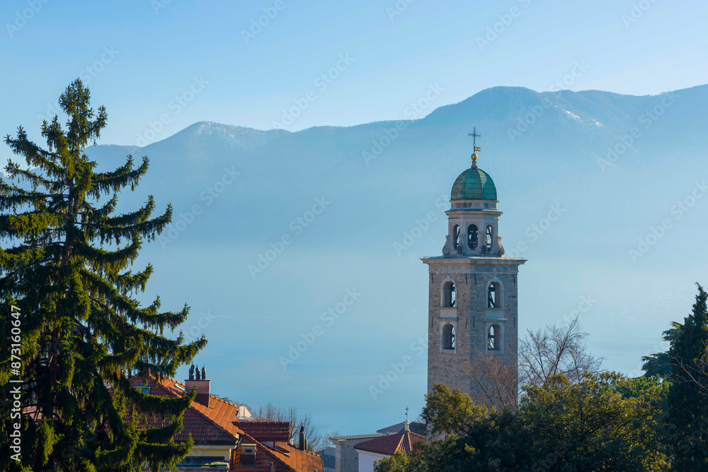 Church Tower and Trees in Mountain Valley in a Misty Sunny Day in City of Lugano, Ticino, Switzerland. Church Tower and Trees in Mountain Valley in a Misty Sunny Day in City of Lugano, Ticino, Switzerland.