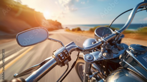 A motorcycle rides down a coastal road