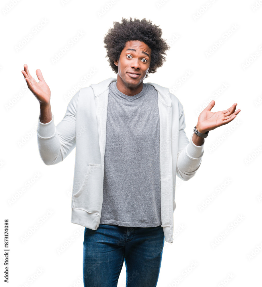 Afro american man wearing sweatshirt over isolated background clueless and confused expression with arms and hands raised. Doubt concept. Afro american man wearing sweatshirt over isolated background clueless and confused expression with arms and hands raised. Doubt concept.