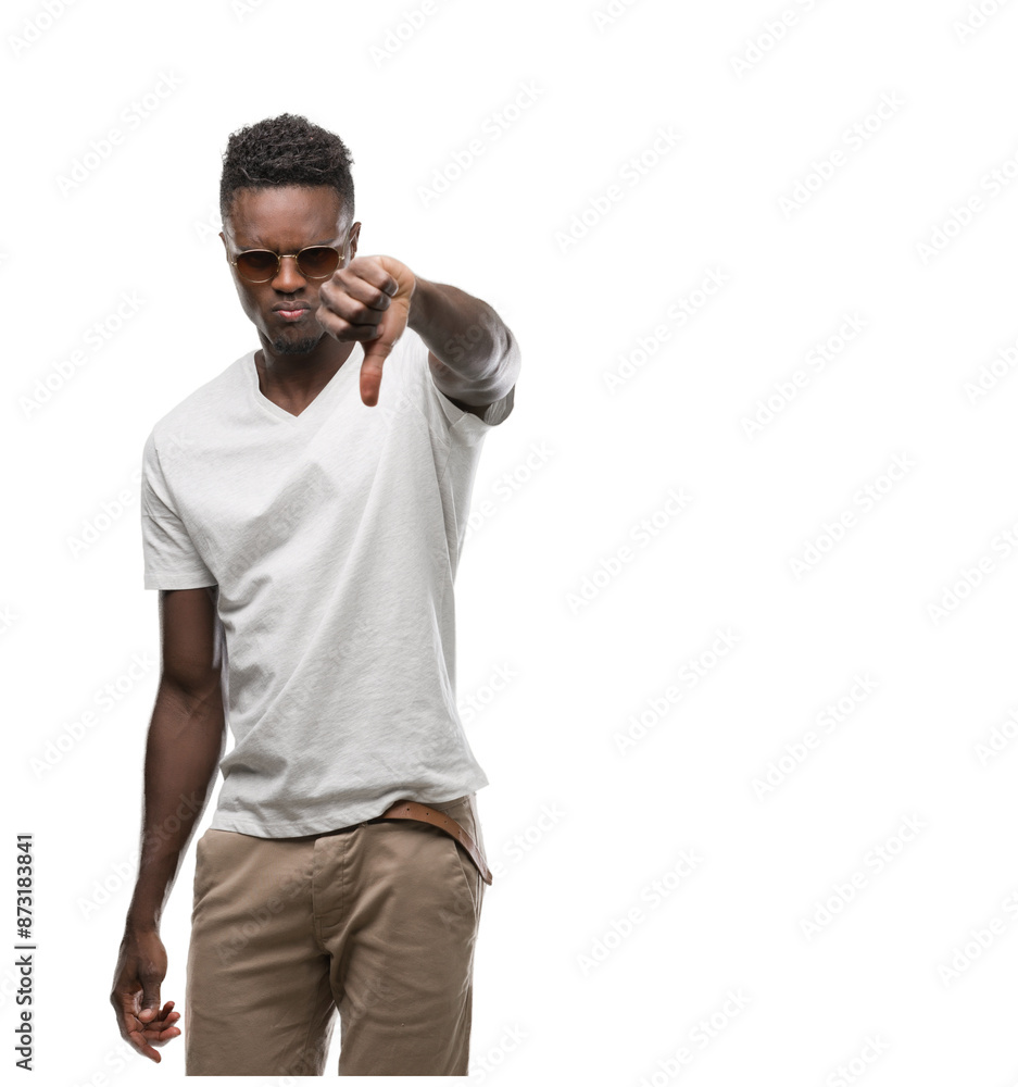 Young african american man wearing sunglasses with angry face, negative sign showing dislike with thumbs down, rejection concept Young african american man wearing sunglasses with angry face, negative sign showing dislike with thumbs down, rejection concept