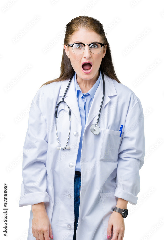 Middle age mature doctor woman wearing medical coat over isolated background afraid and shocked with surprise expression, fear and excited face. Middle age mature doctor woman wearing medical coat over isolated background afraid and shocked with surprise expression, fear and excited face.