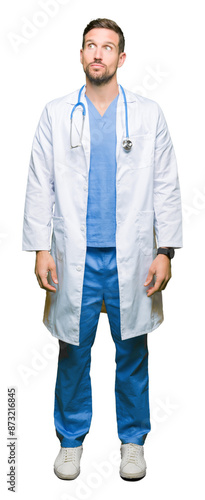 Handsome doctor man wearing medical uniform over isolated background smiling looking side and staring away thinking.