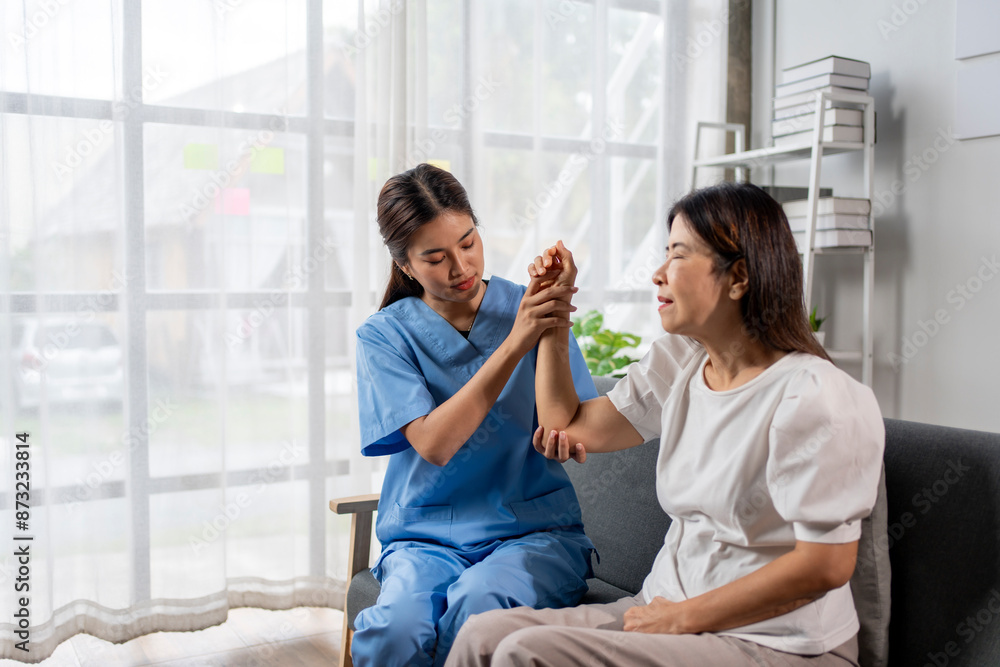 A woman in a blue uniform is helping another woman with her arm A woman in a blue uniform is helping another woman with her arm