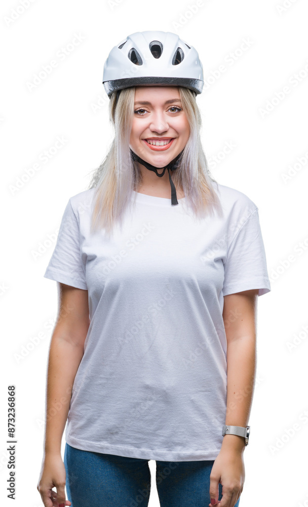 Young blonde woman wearing cyclist security helmet over isolated background with a happy and cool smile on face. Lucky person. Young blonde woman wearing cyclist security helmet over isolated background with a happy and cool smile on face. Lucky person.