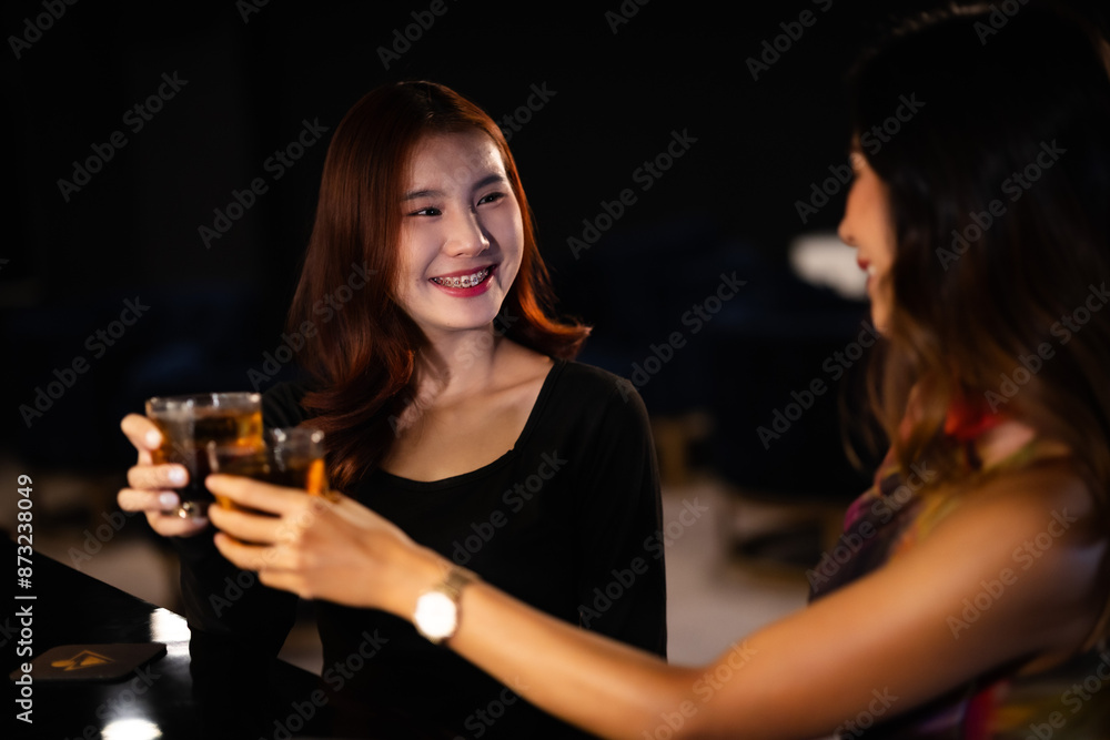 Two women at a nightclub Drink alcohol, talk, party, dance together happily. Two women at a nightclub Drink alcohol, talk, party, dance together happily.