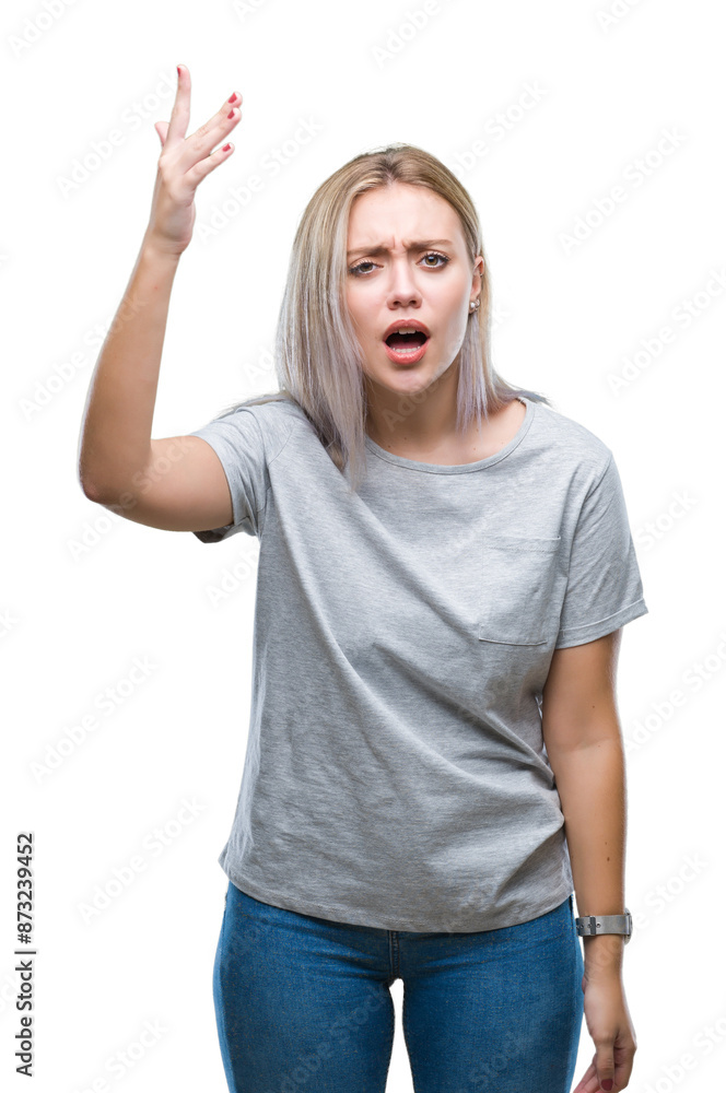 Young blonde woman over isolated background angry and mad raising fist frustrated and furious while shouting with anger. Rage and aggressive concept. Young blonde woman over isolated background angry and mad raising fist frustrated and furious while shouting with anger. Rage and aggressive concept.