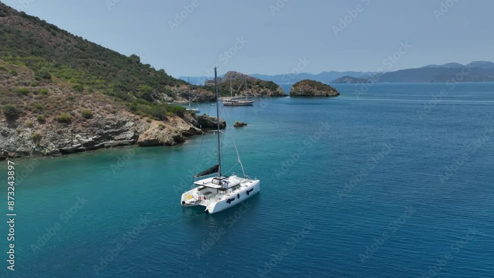 Aerial view of a moored yacht boat in beautiful calm sea bay with turquoise water near Fethiye, Turkey. Full circle around luxury Aerial view of a moored yacht boat in beautiful calm sea bay with turquoise water near Fethiye, Turkey. Full circle around luxury