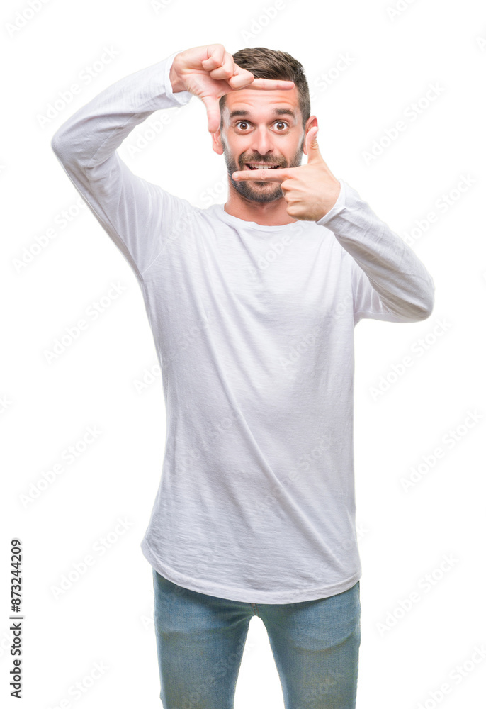 Fototapeta premium Young handsome man over isolated background smiling making frame with hands and fingers with happy face. Creativity and photography concept.