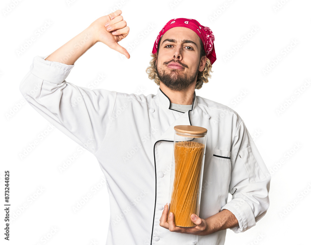 Young chef holds pasta sauce jar in studio feels proud and self confident, example to follow. Young chef holds pasta sauce jar in studio feels proud and self confident, example to follow.