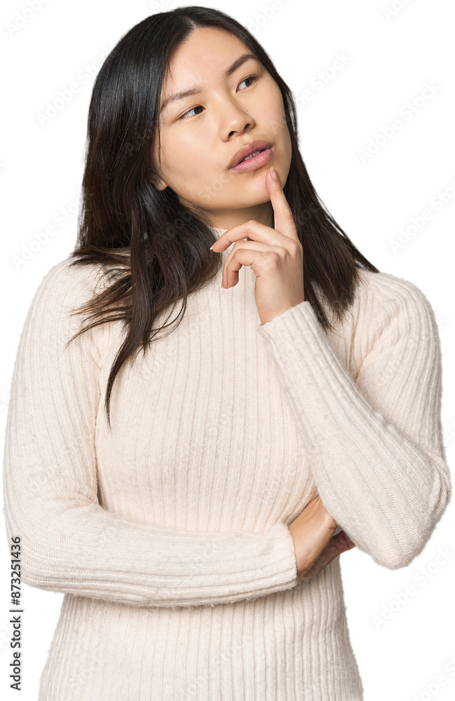 Young Chinese woman looking sideways with doubtful and skeptical expression. Young Chinese woman looking sideways with doubtful and skeptical expression.