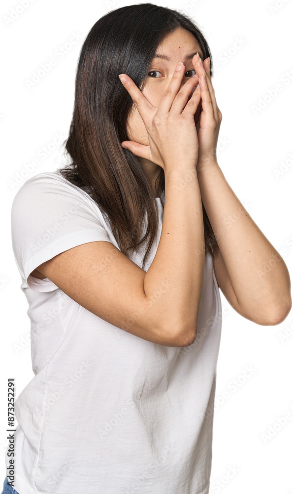 Young Chinese woman blink through fingers frightened and nervous. Young Chinese woman blink through fingers frightened and nervous.