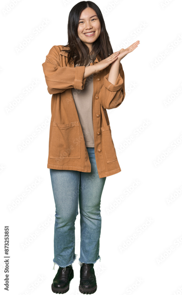 Full-body young Chinese woman feeling energetic and comfortable, rubbing hands confident. Full-body young Chinese woman feeling energetic and comfortable, rubbing hands confident.