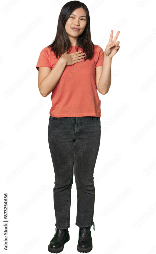Full-body young Chinese woman taking an oath, putting hand on chest. Full-body young Chinese woman taking an oath, putting hand on chest.