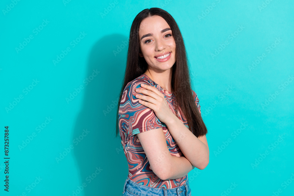 Photo of charming girly woman wear print shirt embrace herself empty space isolated turquoise color background Photo of charming girly woman wear print shirt embrace herself empty space isolated turquoise color background
