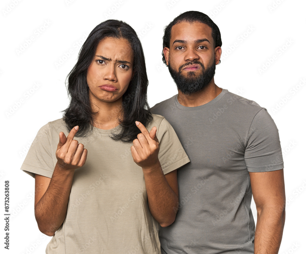 Young Latino couple in studio showing that she has no money. Young Latino couple in studio showing that she has no money.