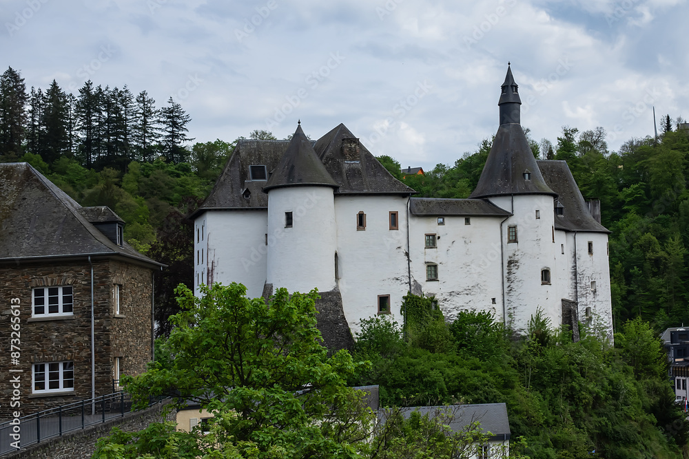 View of Clervaux Castle (Chateau de Clervaux) in Clervaux in Northern Luxembourg, dates back to XII century. Castle stands at a height of 365 meters on a rocky spur above town. Clervaux, Luxembourg. View of Clervaux Castle (Chateau de Clervaux) in Clervaux in Northern Luxembourg, dates back to XII century. Castle stands at a height of 365 meters on a rocky spur above town. Clervaux, Luxembourg.