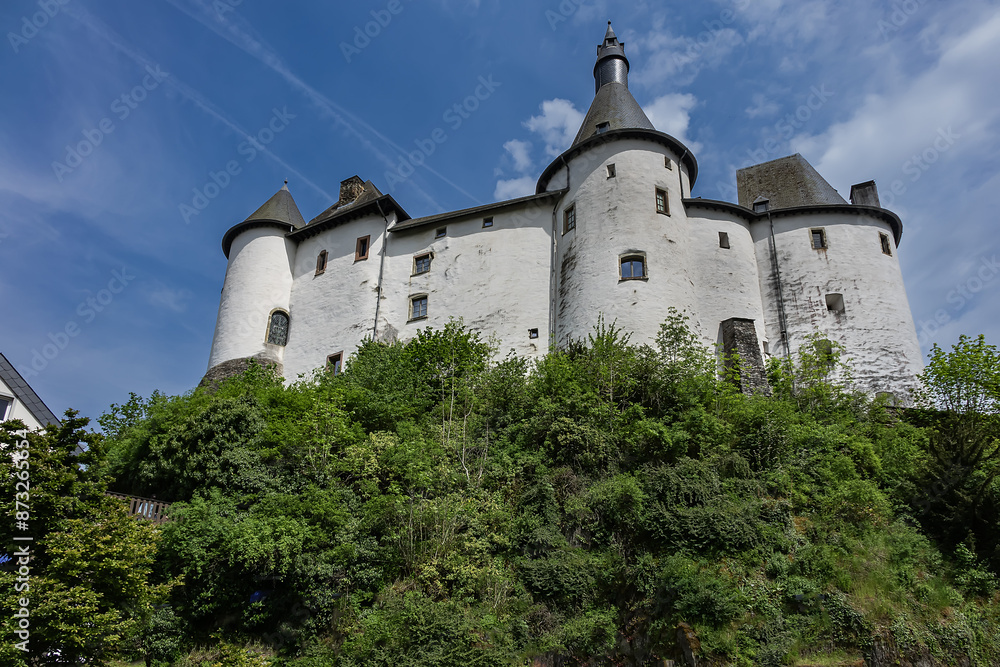 View of Clervaux Castle (Chateau de Clervaux) in Clervaux in Northern Luxembourg, dates back to XII century. Castle stands at a height of 365 meters on a rocky spur above town. Clervaux, Luxembourg. View of Clervaux Castle (Chateau de Clervaux) in Clervaux in Northern Luxembourg, dates back to XII century. Castle stands at a height of 365 meters on a rocky spur above town. Clervaux, Luxembourg.