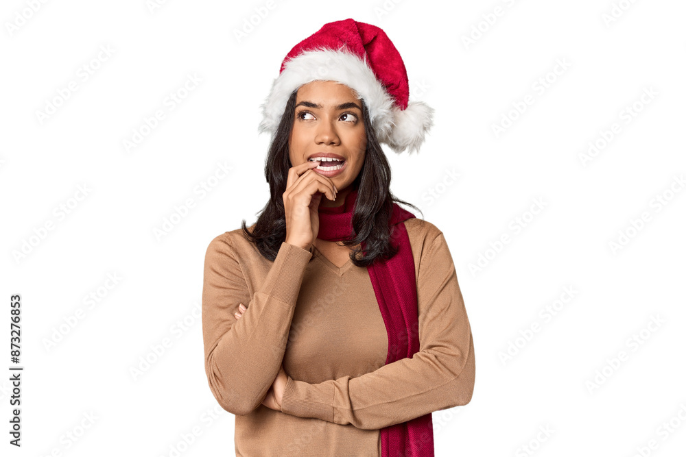Filipino in Christmas attire and Santa hat relaxed thinking about something looking at a copy space. Filipino in Christmas attire and Santa hat relaxed thinking about something looking at a copy space.
