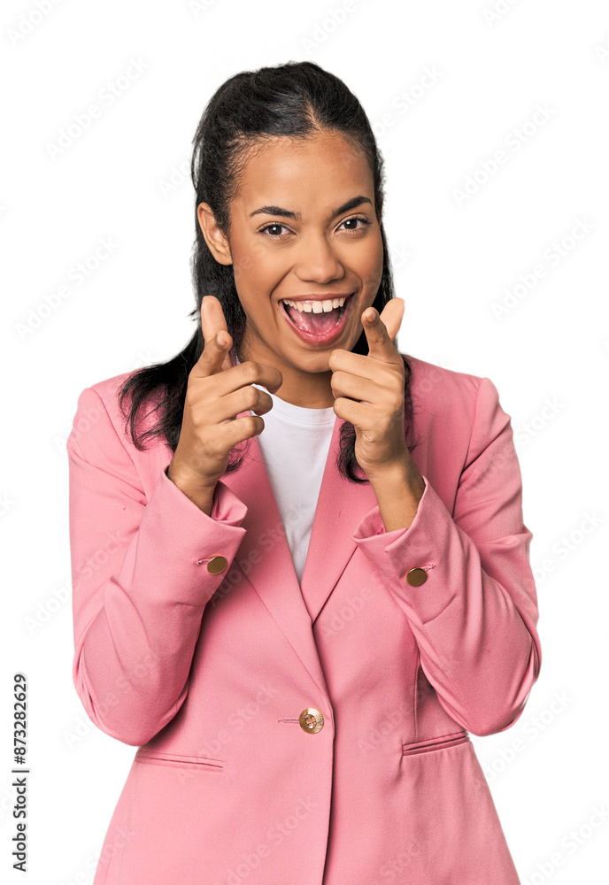 Young Filipina in pink suit pointing to front with fingers.