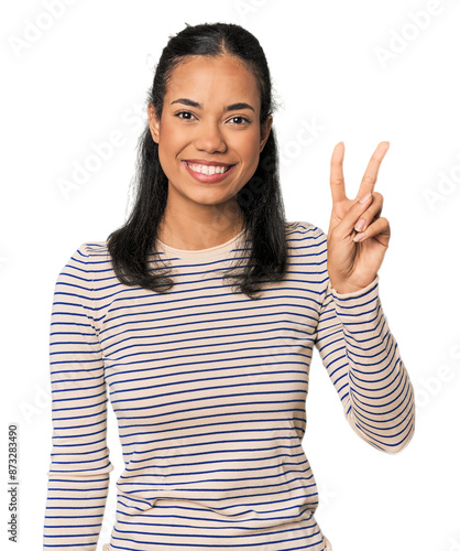 Young Filipina woman joyful and carefree showing a peace symbol with fingers.