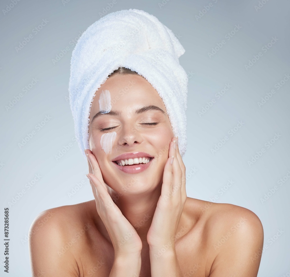Woman, application and cream for clear skin in studio, hydration and beauty on blue background. Female person, dermatology and lotion for facial treatment, skincare and hyaluronic acid moisturizer Woman, application and cream for clear skin in studio, hydration and beauty on blue background. Female person, dermatology and lotion for facial treatment, skincare and hyaluronic acid moisturizer