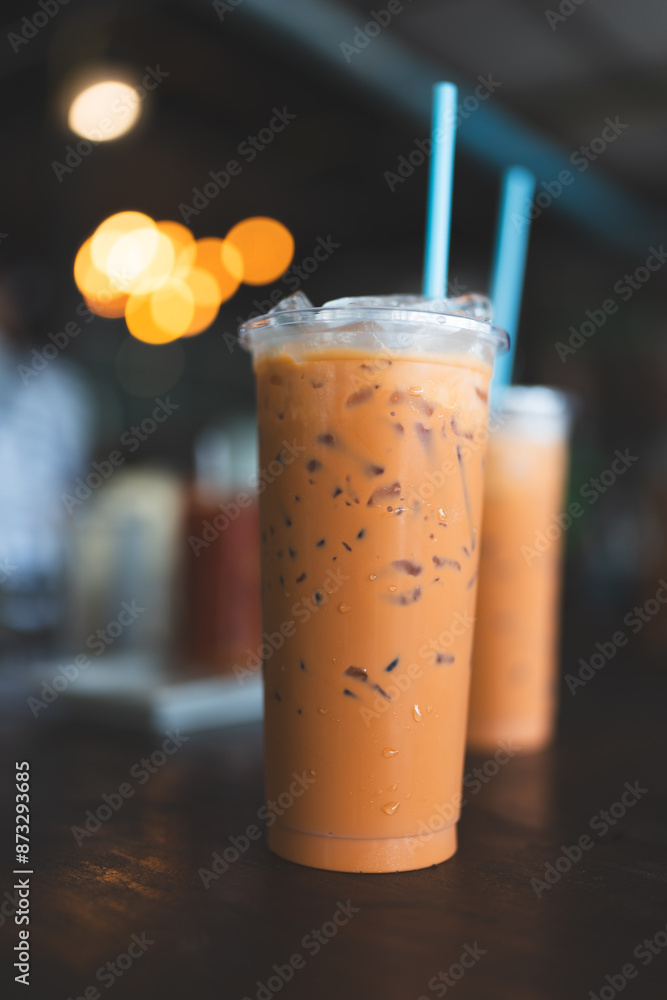 Realistic plastic cup of iced fresh Thai milk tea made from real tea leaves, popular menu in Thailand Realistic plastic cup of iced fresh Thai milk tea made from real tea leaves, popular menu in Thailand