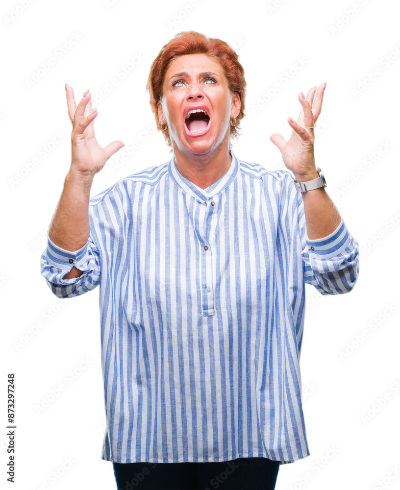 Atrractive senior caucasian redhead woman over isolated background crazy and mad shouting and yelling with aggressive expression and arms raised. Frustration concept. Atrractive senior caucasian redhead woman over isolated background crazy and mad shouting and yelling with aggressive expression and arms raised. Frustration concept.