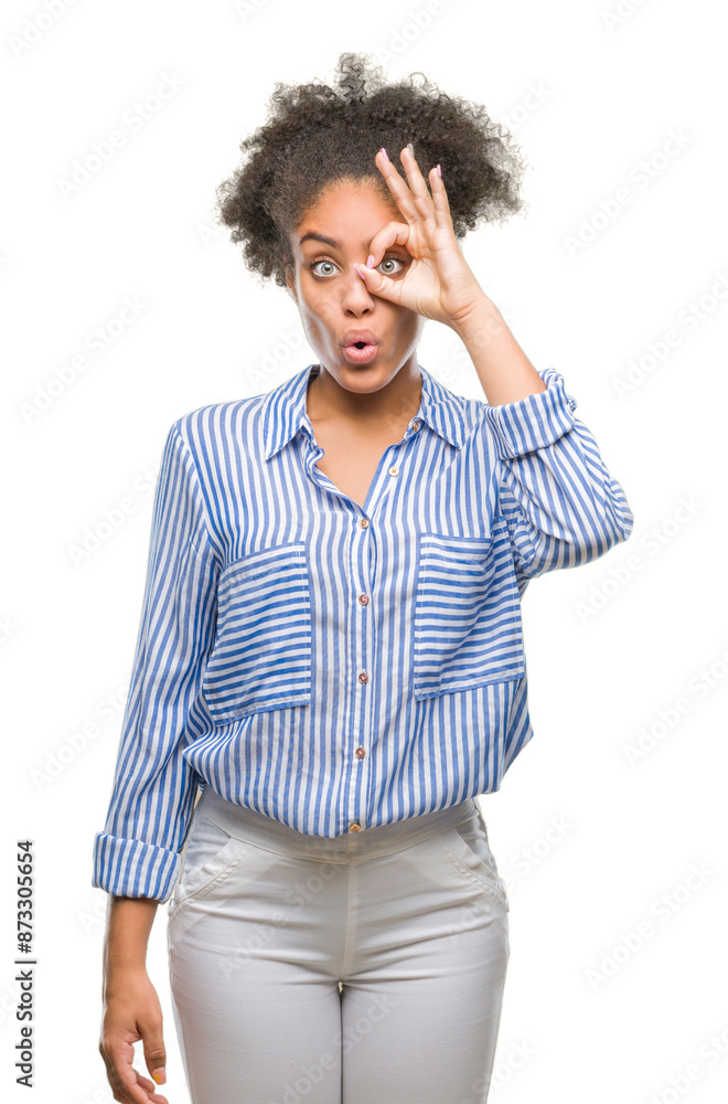 Young afro american woman over isolated background doing ok gesture shocked with surprised face, eye looking through fingers. Unbelieving expression. Young afro american woman over isolated background doing ok gesture shocked with surprised face, eye looking through fingers. Unbelieving expression.